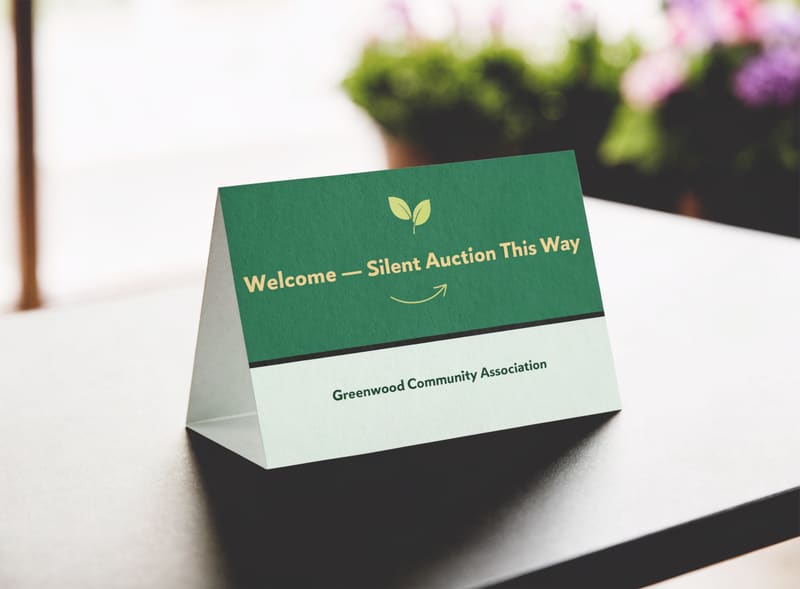 Sample event signage reading “Welcome — Silent Auction This Way” for a fictional community association